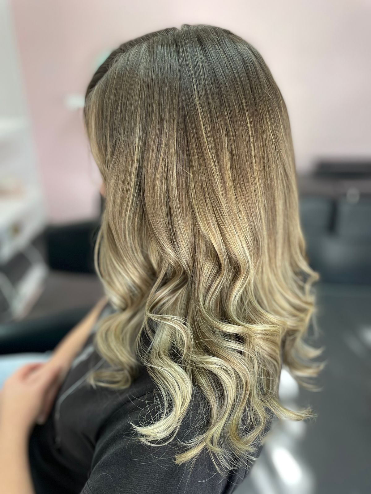 Sun-lit balayage transformation with soft curls at Kiss & Tell hair salon, Pinelands Cape Town
